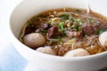 wide rice noodle soup with vegetables and beef