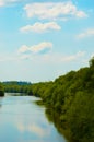 River, blue sky, white clouds and green trees. nature in summer. Royalty Free Stock Photo