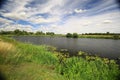 Wide river Ehle in Germany under blue sky with green grass and distant trees Royalty Free Stock Photo