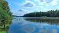 Wide river with green coasts and sky with clouds Royalty Free Stock Photo