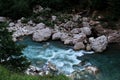 Wide river among mountains of gorge and green vegetation around. Stormy mountain river with bluish tinge from sky flows quickly Royalty Free Stock Photo