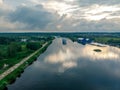 Wide river reflects clouds. the ship moves towards