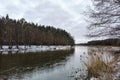 A wide river with turns in the middle of the forest in winter Royalty Free Stock Photo
