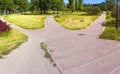 The wide road is divided into three alleys in the park, going in different directions. Conceptual summer landscape Royalty Free Stock Photo