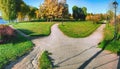 The wide road divides into three alleys in the park, leading in different directions. Autumn concept landscape Royalty Free Stock Photo
