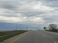 Road shot with road signs and no traffic early on a spring day in Norman, Oklahoma