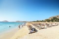 Wide sand beach with tourists, umbrellas and beds in Mykonos, Greece. Royalty Free Stock Photo
