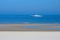 Wide sandy beach near the North Sea. Beautiful promenade of Ostend in the early morning. An amusing