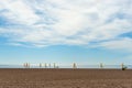 Wide sandy Mediterranean beach with fleet of small yachts