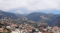 Wide scenic panoramic aerial cityscape of the city of funchal in Madeira with buildings of the city in front of mountains with