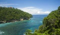 Wide scenic view at tropical paradise island of Bali of turquoise sea and cliffs in the horizon under a blue sky in Summer Royalty Free Stock Photo