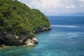 Wide scenic view at tropical paradise island of Bali of turquoise sea and cliffs in the horizon under a blue sky in Summer Royalty Free Stock Photo