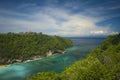 Wide scenic view at tropical paradise island of Bali of turquoise sea and cliffs in the horizon under a blue sky in Summer Royalty Free Stock Photo