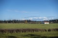 Wide, scenic view of a white barn on a large plot of farm land in the Pacific Northwest Royalty Free Stock Photo