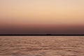 A wide seascape shoot with very well composed colors and black horizon from izmir bay - orange color dominated