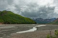 Wide semi-dry river bed under cloudscape, Denali Park, Alaska, USA