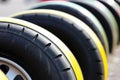 The wide set tires of a classic yellow and black dragster racing car ready for the track. Speed drive concept. AI