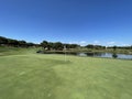 Beautiful golf hole on a large lake Royalty Free Stock Photo