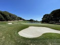 Rear shot of a golf hole with bunker, green and lake Royalty Free Stock Photo