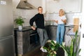 Wide shot of angry emotional blonde woman scolding, raising voice, shouting at ignoring tired boyfriend standing in Royalty Free Stock Photo