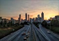 Wide shot of beautiful high-rise buildings and highways with cars under the colorful sky at sunset Royalty Free Stock Photo