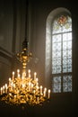 Wide Shot of a Big Window and an Antique Chandelier in a Grand Church. Beautiful Stained Glass