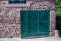 Wide shot of a blue gate door of a brick house