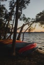 Wide Shot Of Canoes And Kayaks Lying In Front Of A Lake Royalty Free Stock Photo