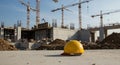 Safety helmet on ground near active building site Royalty Free Stock Photo