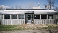 Wide shot of an empty gray diner during daytime