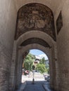 wide shot of a fresco painted on arched entrance into the old city of trento