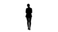 Silhouette Casual female in a suit texting on her phone.