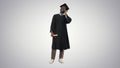 Smiling african american male student in graduation robe talking Royalty Free Stock Photo