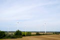 Wide shot of a group of wind turbines on a plain field in Austria