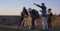 Friends stargazing together using a professional telescope