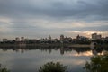 Wide shot of Harrisburg city skyline reflecting on the water at sunrise