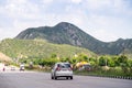 Wide shot of indian highway with trucks, cars, bikes, motorcycle and more on a wide asphalt road with green plants