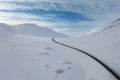 Wide Shot of Jeep Car driving on Iceland Road with Snow white Mountains and Sunset countryside, Winter. Road trip in Nordic Royalty Free Stock Photo