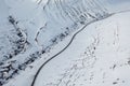 Wide Shot of Jeep Car driving on Iceland Road with Snow white Mountains and Sunset countryside, Winter. Road trip in Nordic Royalty Free Stock Photo