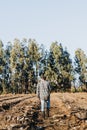 Wide shot of a latin farmer man walking in middle of the farmland. Royalty Free Stock Photo