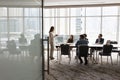 Wide shot of multiethnic business team talking at meeting table Royalty Free Stock Photo