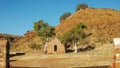 Wide shot of an old hut and ghost gums at the overland telegraph station, barrow creek Royalty Free Stock Photo