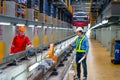 Wide shot of professional engineer and technician stand near railroad tracks of electrical or sky train and discuss about Royalty Free Stock Photo