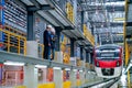 Wide shot of professional technician and engineer workers stand near railroad tracks in front of electrical or metro train in