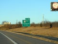 Roadside sign along Interstate Highway 35 in winter  time, with distance to Comanche, Oklahoma City Royalty Free Stock Photo