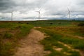 Wide Shot Of Sustainable Wind Turbines or Windmills At A Farm field In Valdorros In Castile and Leon, Burgos, Spain. Cloudy epic