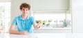 Wide shot of young handsome man at home smiling friendly offering handshake as greeting and welcoming Royalty Free Stock Photo