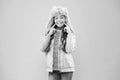 Wide sincere smile. Warm hat for cold weather. Faux fur trend. Girl long curly hair wear fur hat with ear flaps pink