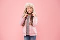 Wide sincere smile. Warm hat for cold weather. Faux fur trend. Girl long curly hair wear fur hat with ear flaps pink