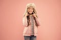 Wide sincere smile. Warm hat for cold weather. Faux fur trend. Girl long curly hair wear fur hat with ear flaps pink